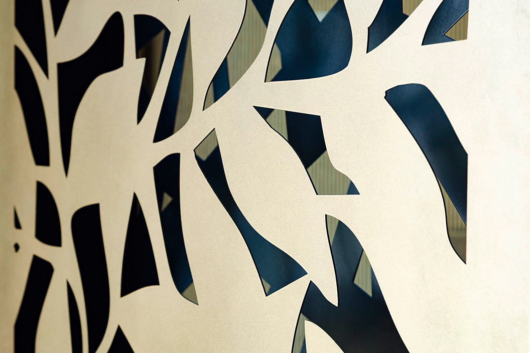 Laser cut panels with golden leaves – organic design of pivot screens